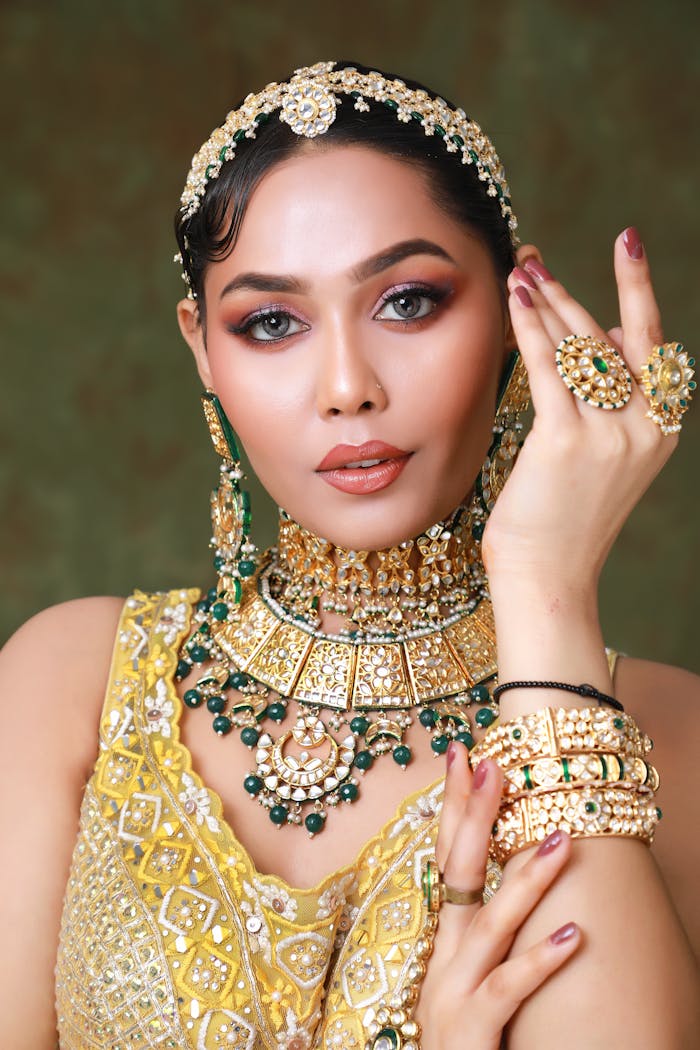 Stunning Indian woman adorned in traditional jewelry and warm-toned makeup.